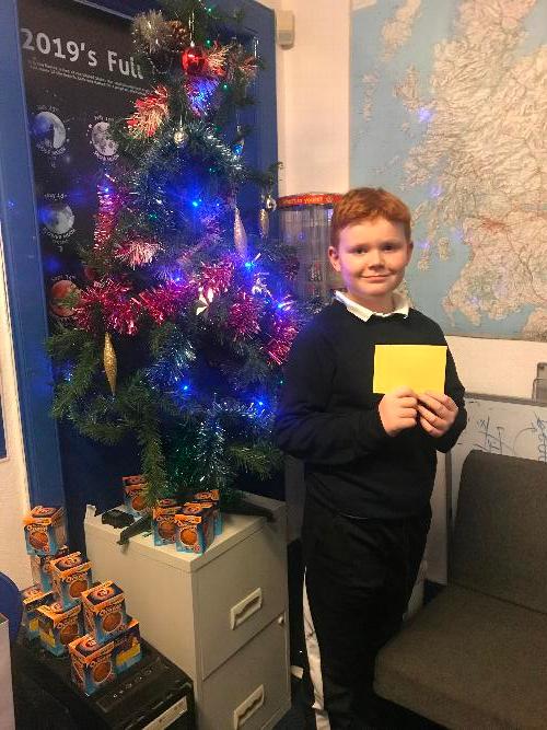 Kai with his voucher Kai receiving his monthly draw voucher